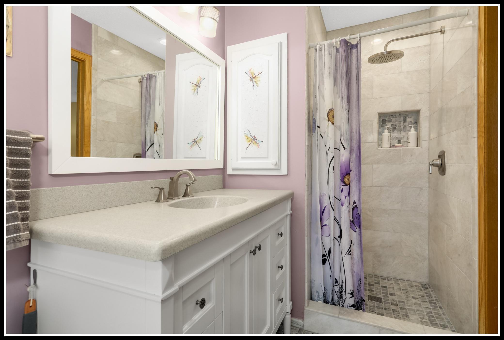 and tiled walk-in shower with rainshower