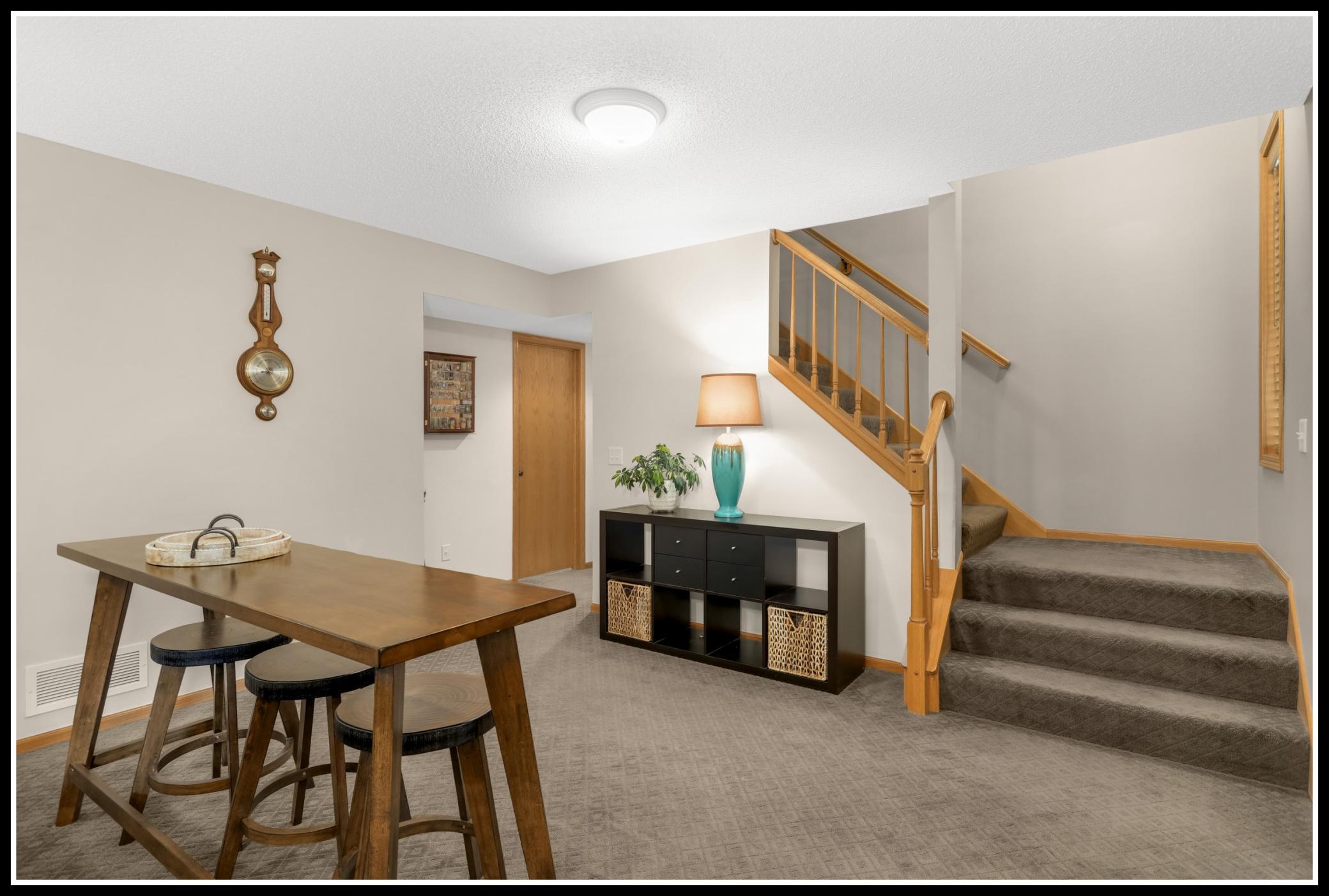Fully finished lower level has an additional living space, a bedroom, and bathroom