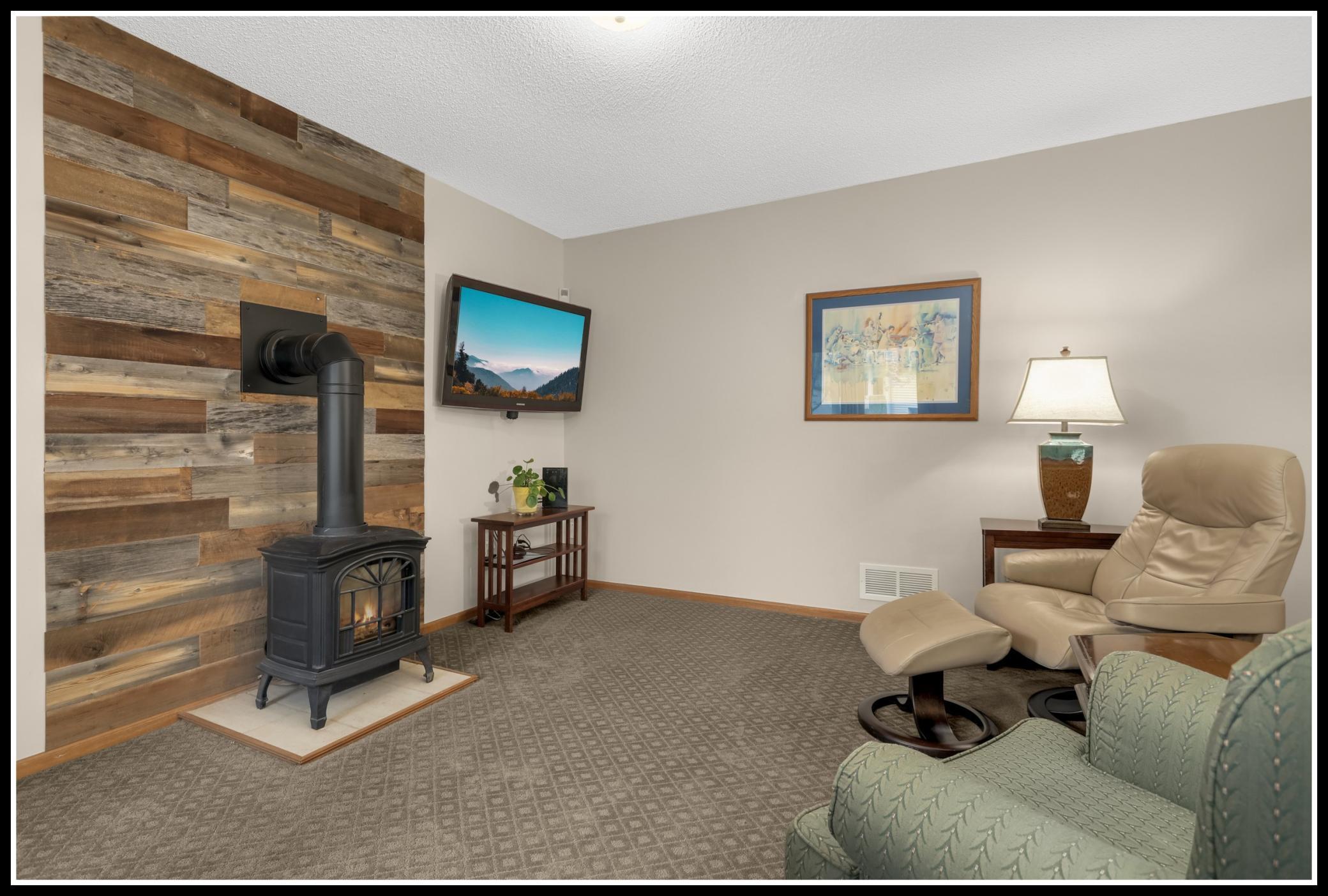 A gas-fueled cast iron stove adds extra warmth and ambiance to the family room
