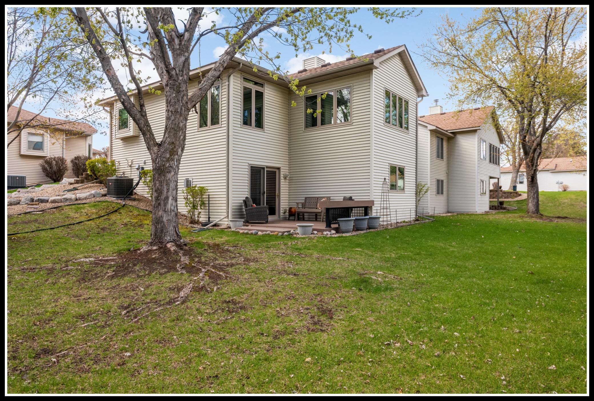Outside, mature trees shade the backyard and deck