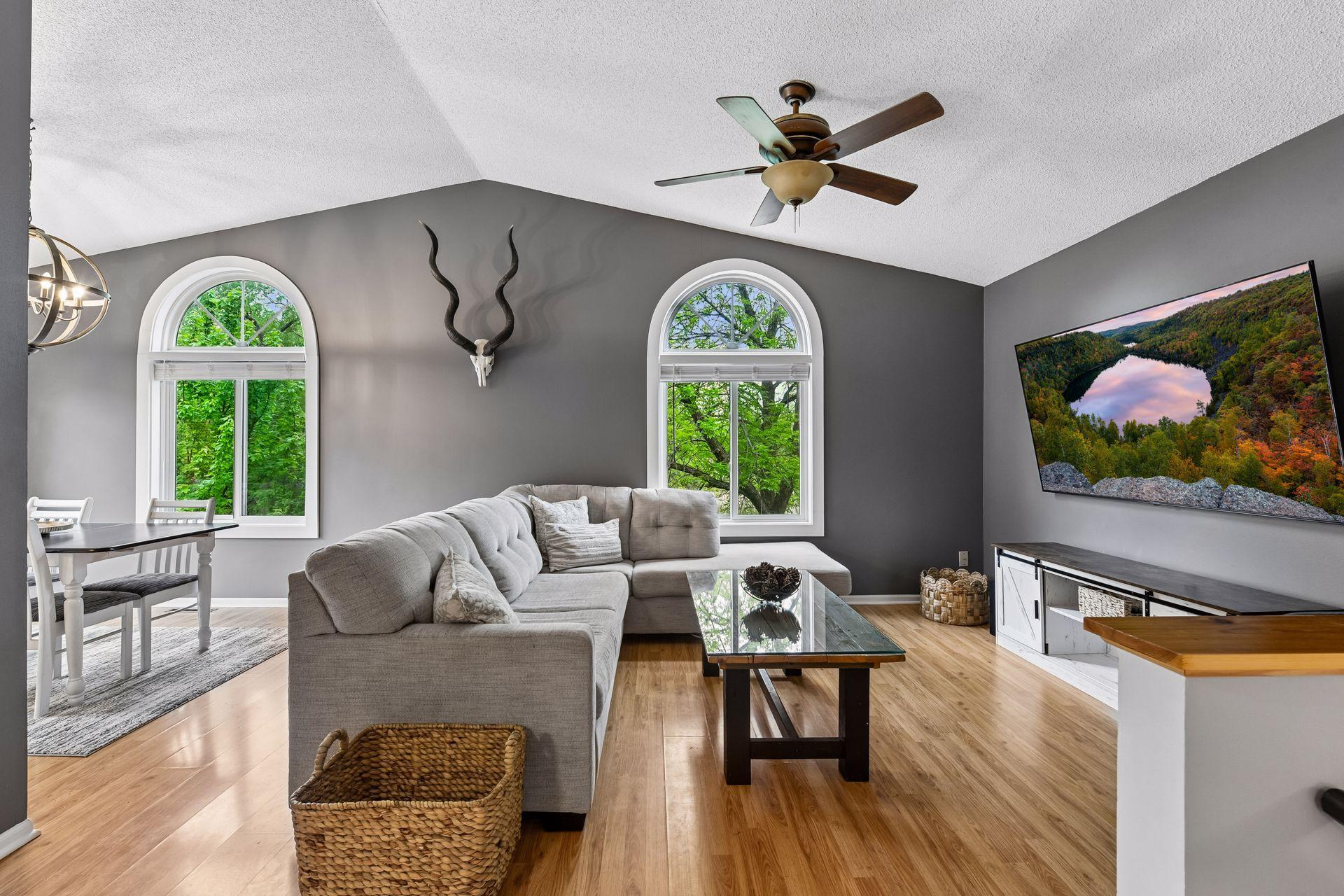 The main level features a spacious kitchen with updated tile flooring, farmhouse sink, and newer gas range with hood, along with a living room, two bedrooms and a full bathroom.