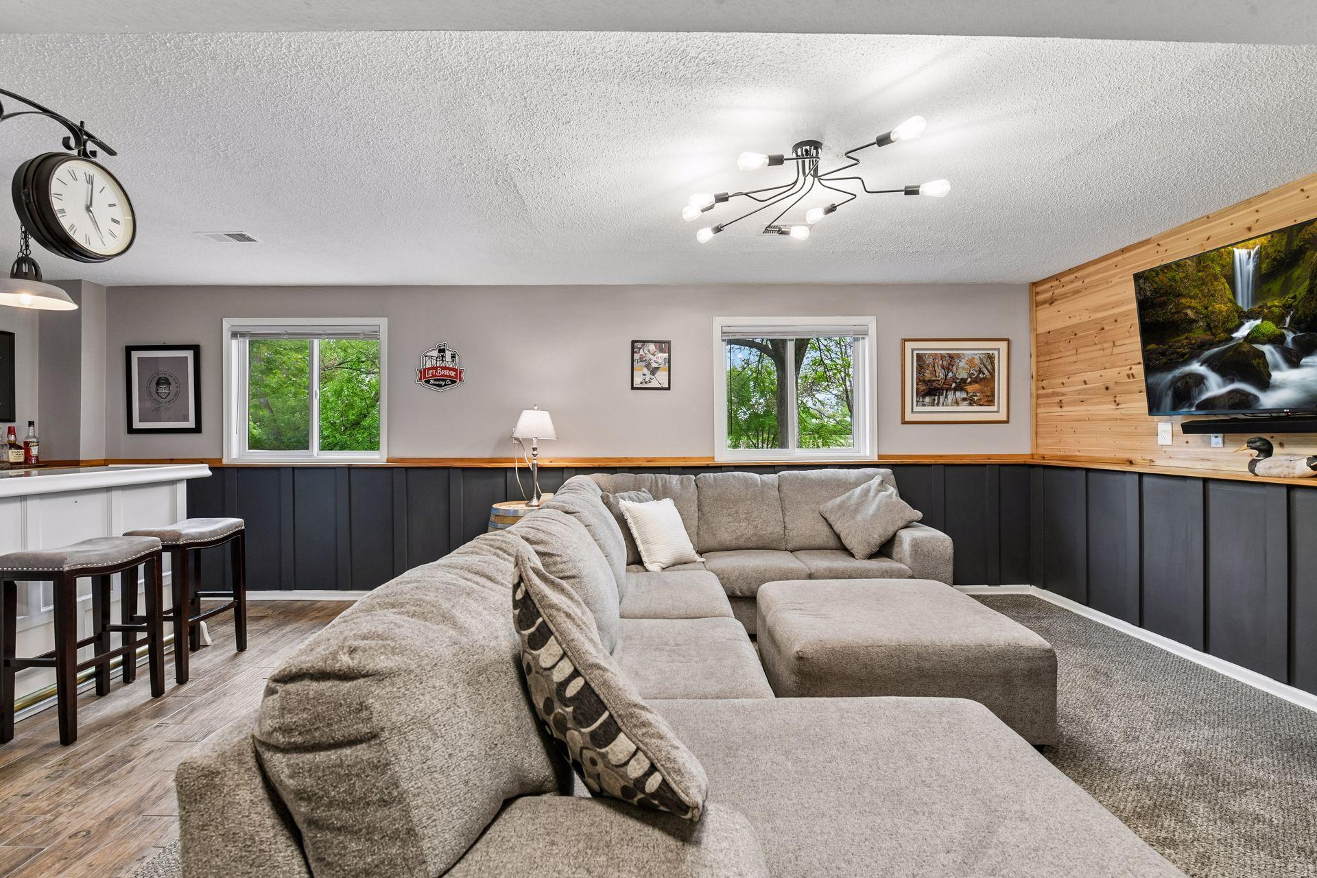 The lower level provides additional living space with a family room and bar area, two bedrooms, three-quarter bathroom, and laundry.