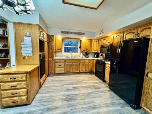 The kitchen features lots of oak cabinetry