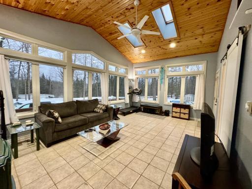 This sunroom is beautiful with its large windows and bright design