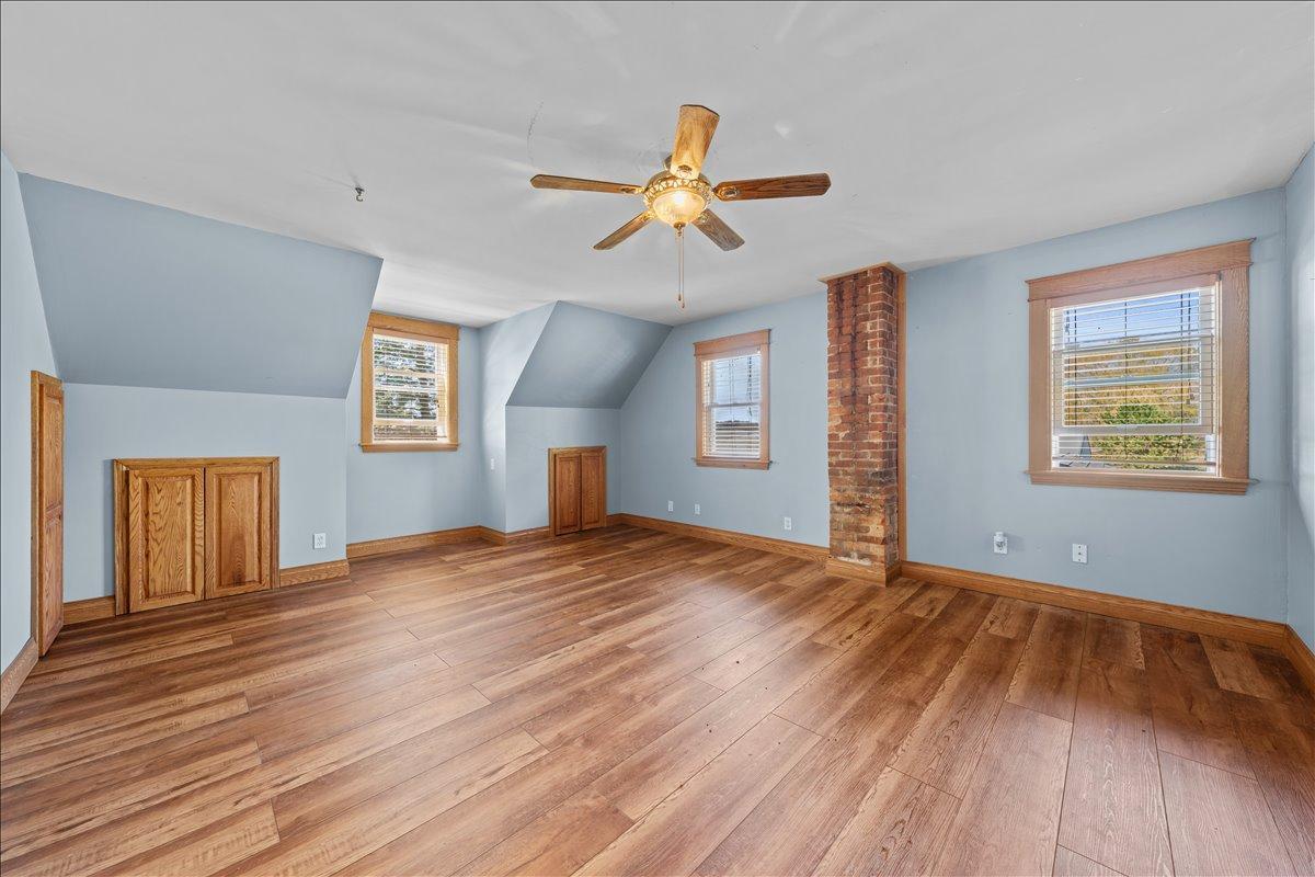 Spacious primary Bedroom has six panel doors and newer plank flooring.