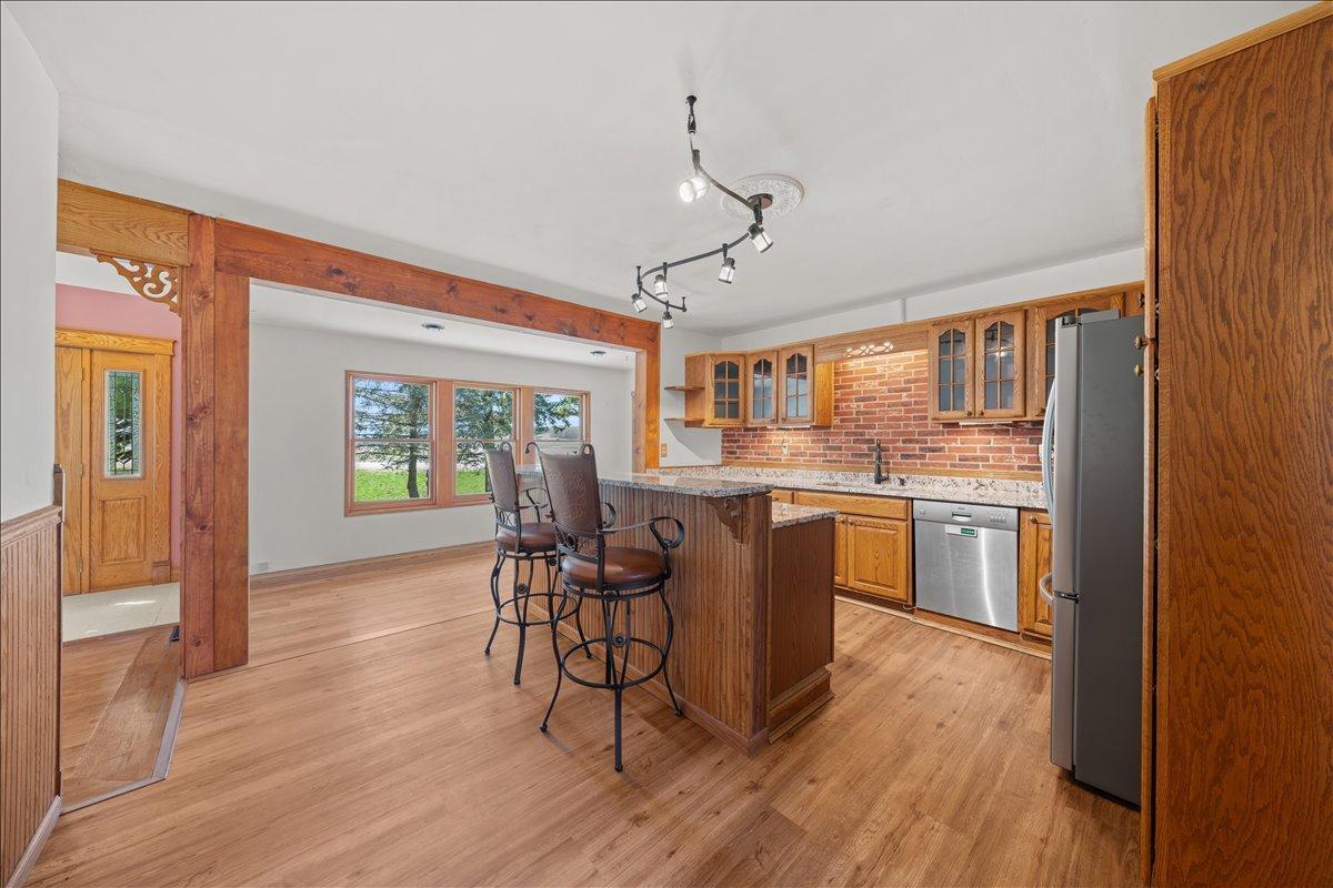 Large bright kitchen with new granite counters, stainless appliances and new flooring.