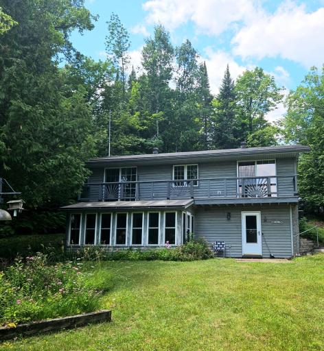 Sunroom and upper balcony off bedrooms, facing the water