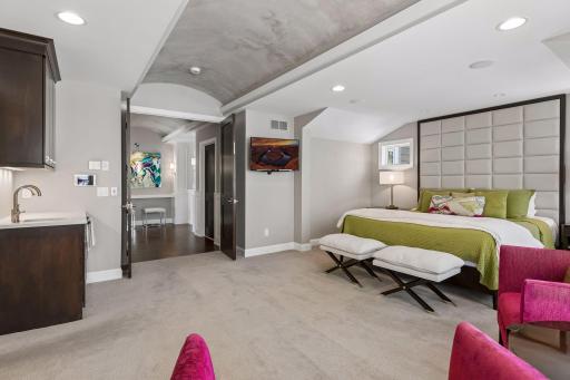 The barrel vaulted hallway ceiling carries through into the primary ensuite