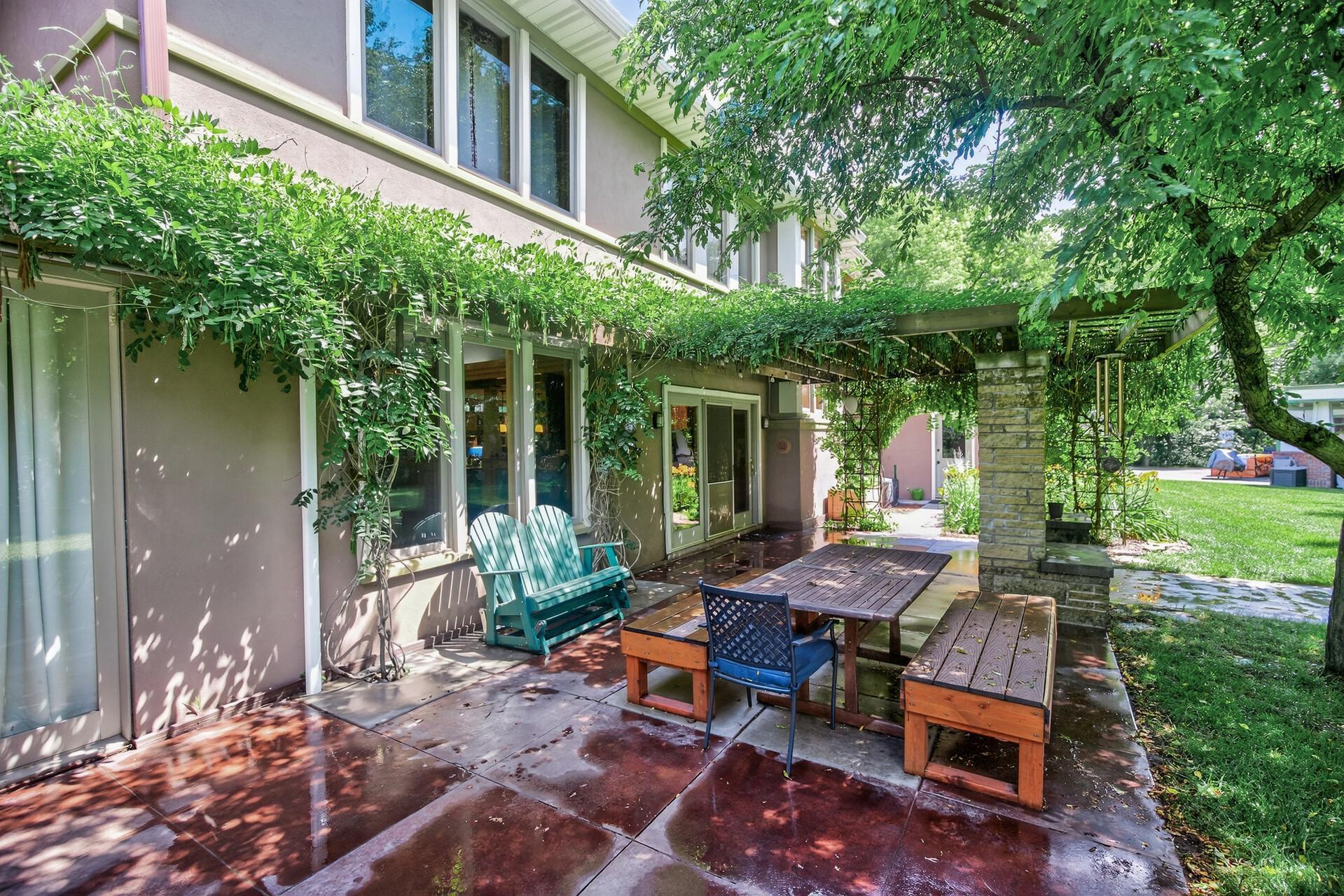 Nice patio area in the back of the home with lots of greenery.
