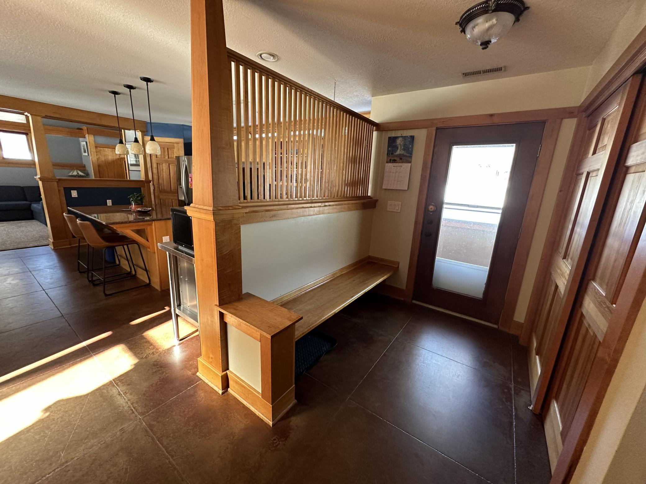 Main floor entry way with a maple bench and a nice big closet for guests jackets/coats.