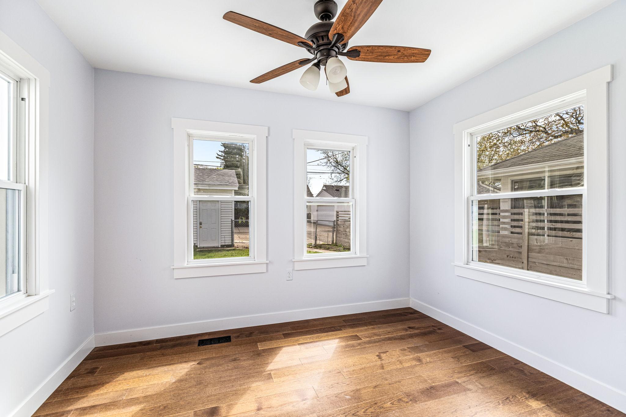 Dining area is filled with light from windows looking out to the backyard.