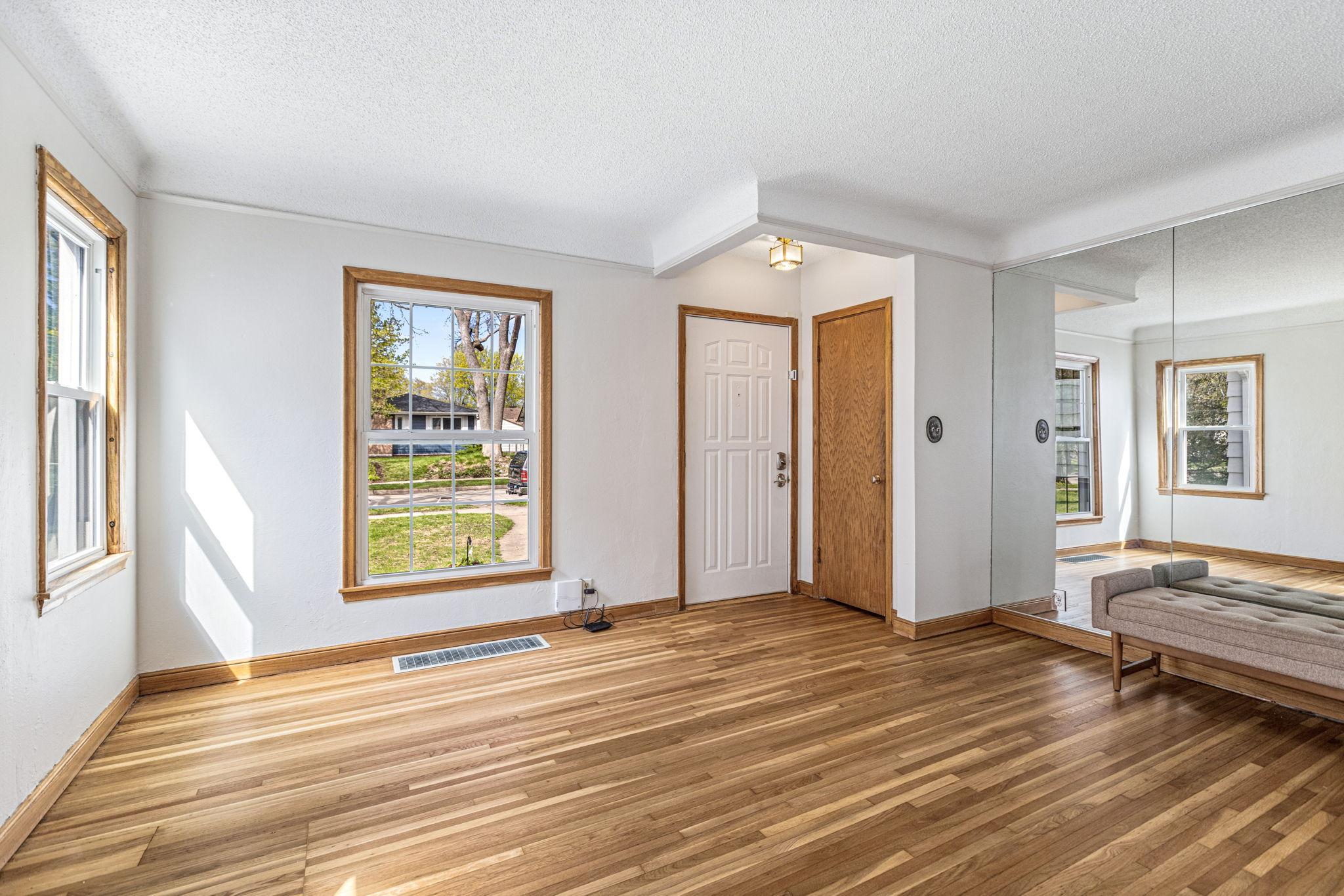 Enter into the charming 1940's living room with gorgeous hardwood floors and coved ceilings.