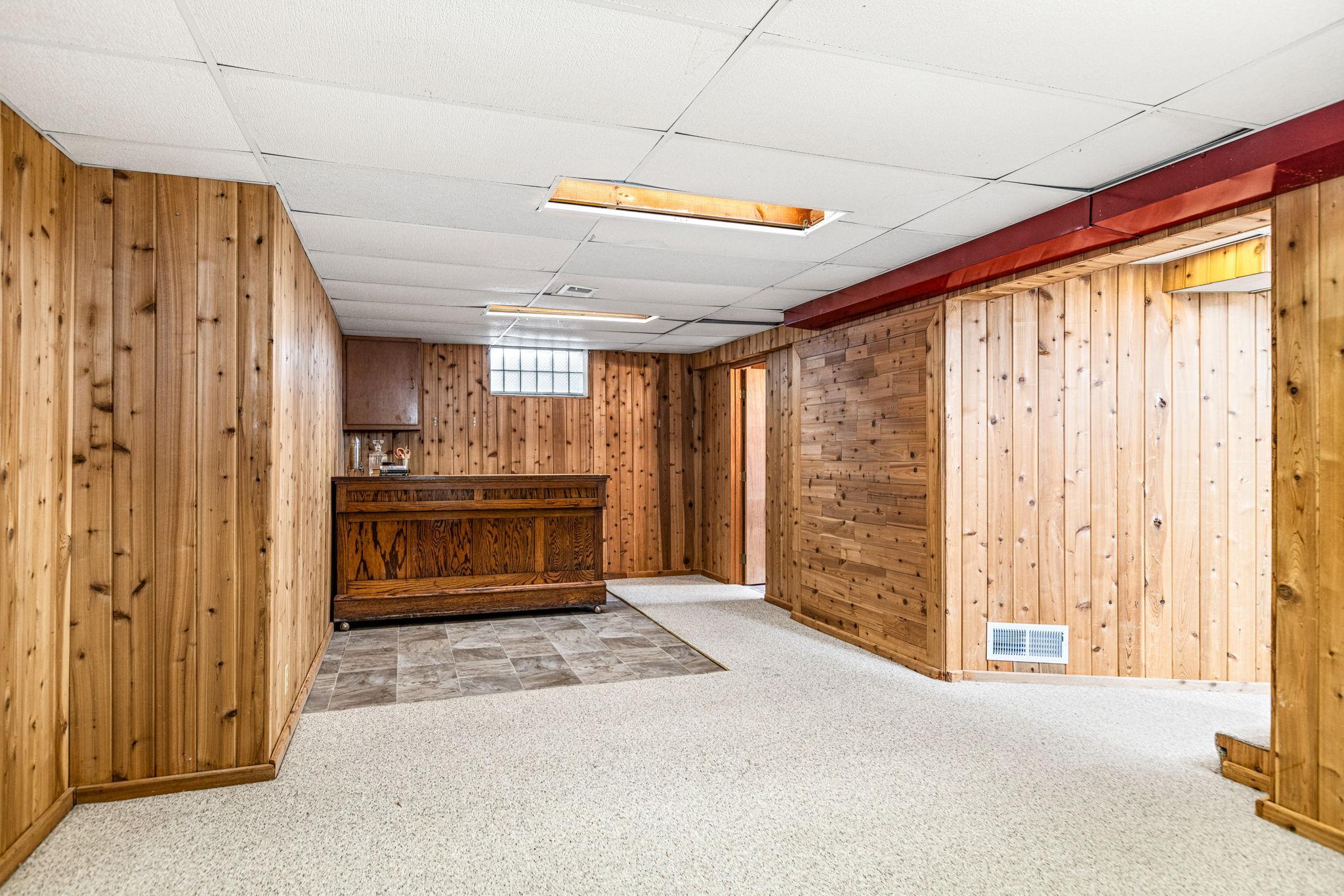 Downstairs there's a spacious family room and vintage bar area.