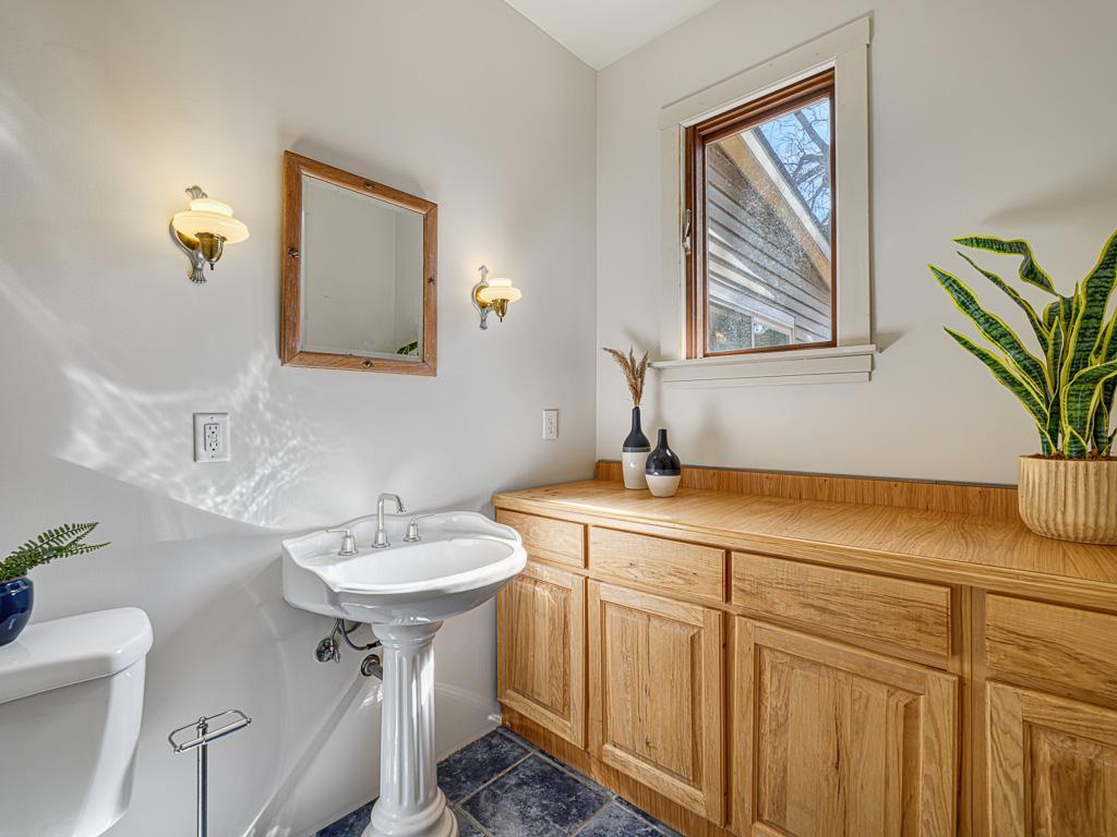 This powder room could easily be converted back to a full bathroom. Previous owner removed bathtub and added a cabinet