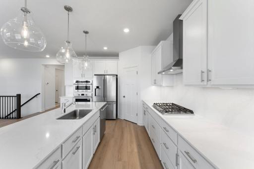 The kitchen features brand-new appliances, ample cabinetry, designer-selected countertops and a pantry for added storage space.