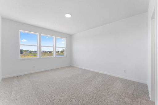 An ownerâs suite sits in a rear corner of the home and is a relaxing oasis with an en-suite bathroom and walk-in closet.