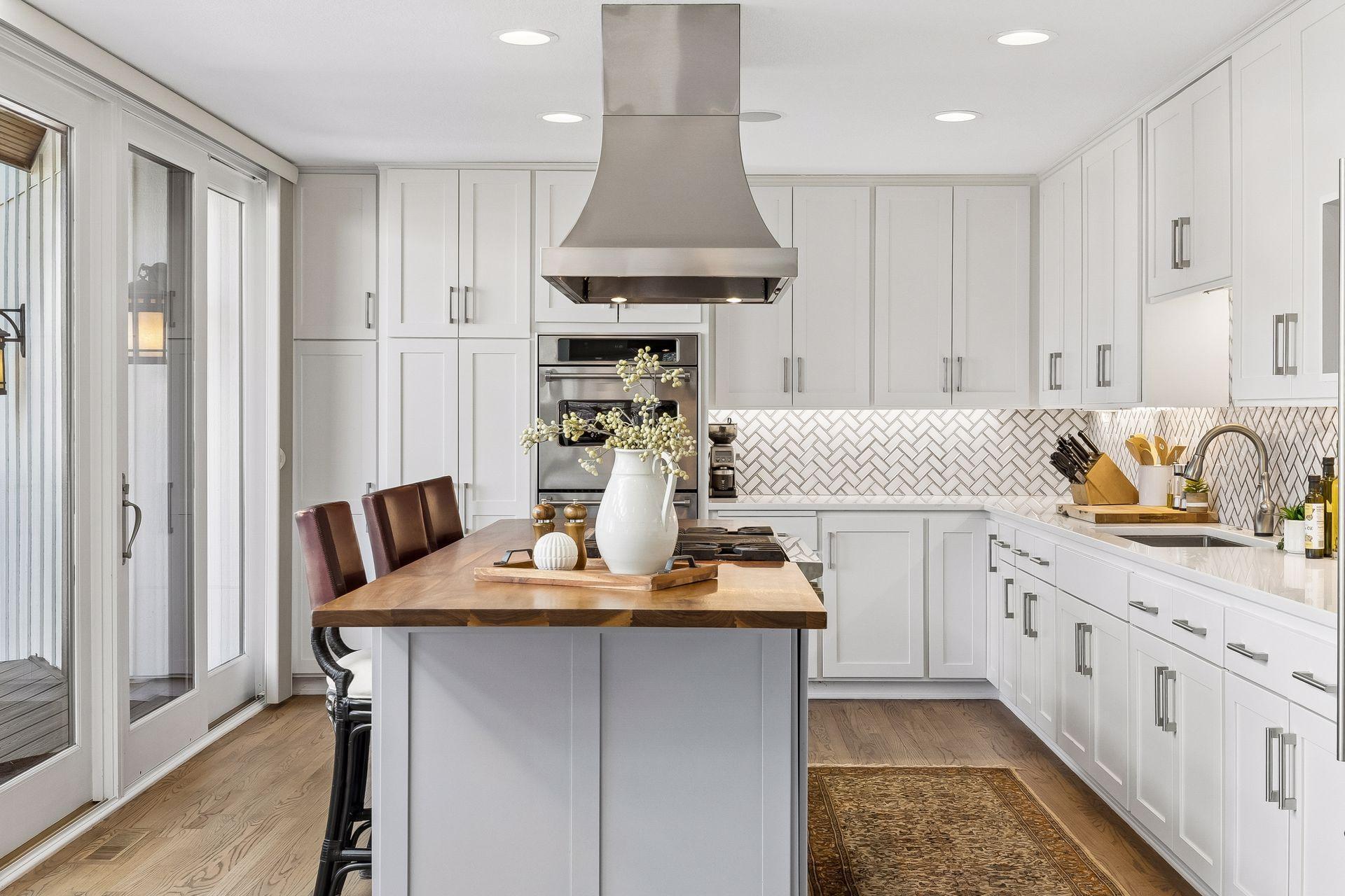 Featuring Custom Cabinets, High-End Appliances, and a Large Walnut Center Island