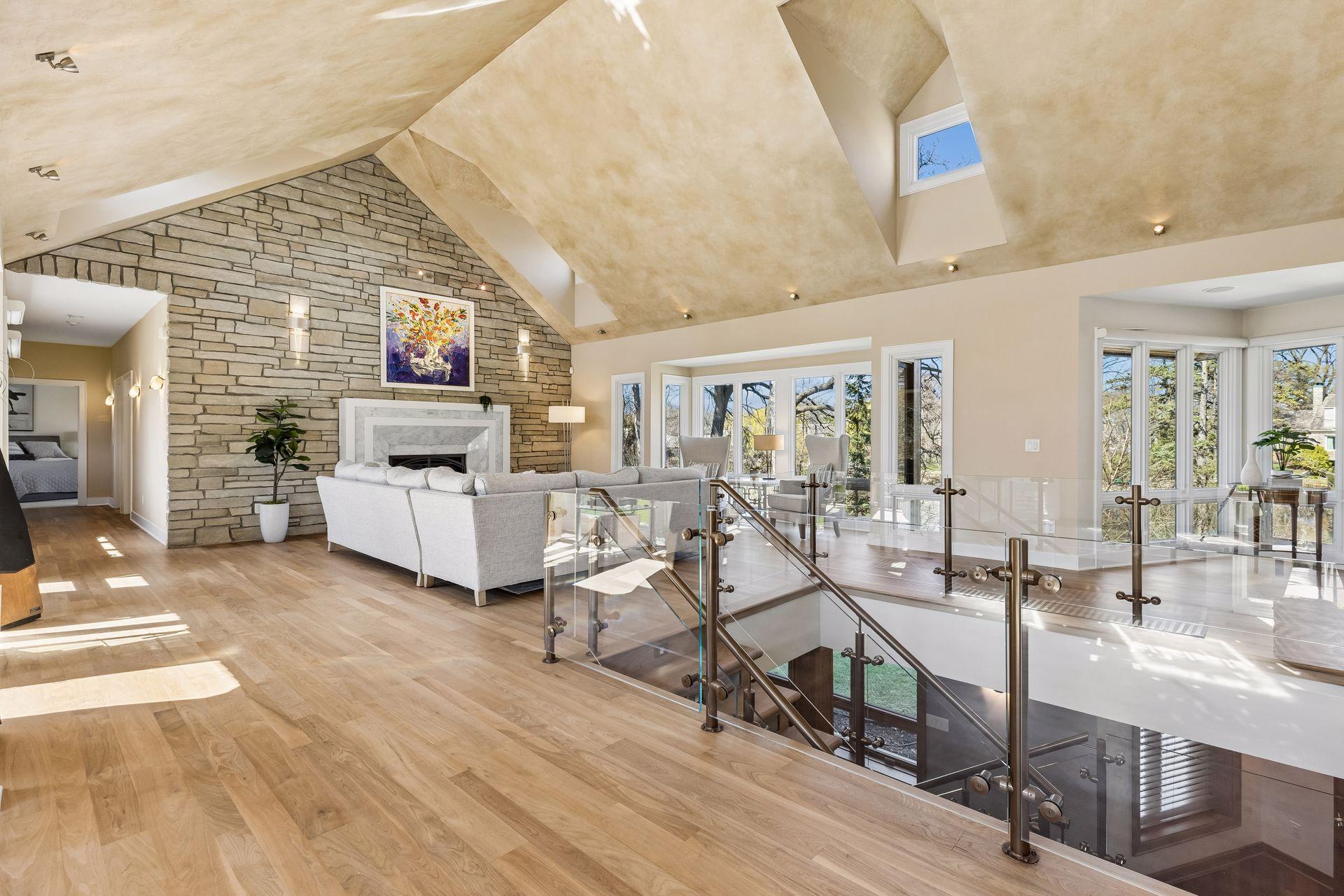 Upon Entrance, a Grand Living Room & Staircase w/ Vaulted Ceilings