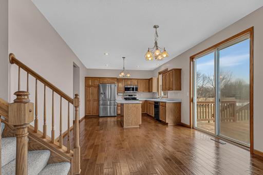 Hand-scraped hardwood floors add warmth and character across the kitchen, dining room, foyer, main level half bath, laundry room, and closets.