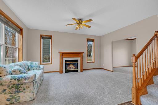The main level living room is centered around a natural gas fireplace, creating a cozy gathering space.
