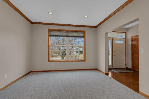 Bonus room just off to the living room and foyer featuring crown molding and LED recessed lighting.