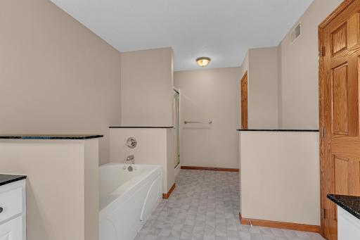 The ensuite bath also features a sit-down shower and a linen closet.