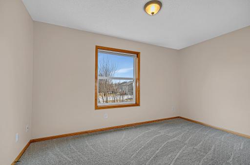 The upper level includes four bedrooms in total, with the third and fourth bedrooms offering walk-in closets with built-in organizers.