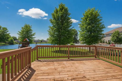 Spacious deck and an exposed aggregate concrete patio overlook the backyard and its peaceful pond settingâperfect for relaxing evenings or entertaining guests.