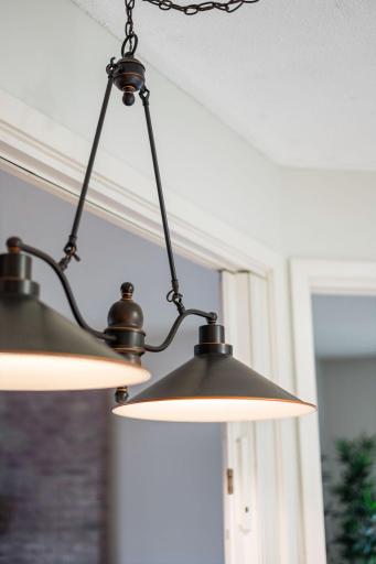 Updated light fixture adds character and warmth to the dining area.