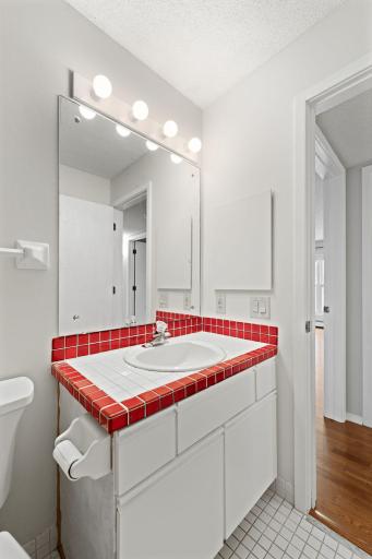 Guest bathroom showcasing vanity and oversized mirror. .