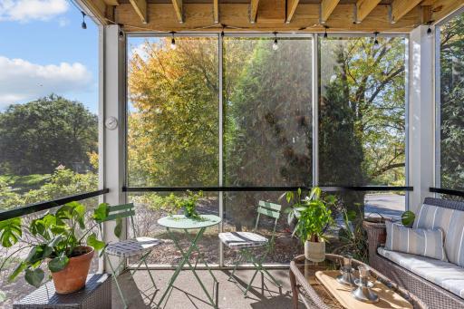 Another view of the screened porch showcasing peaceful outdoor living space.