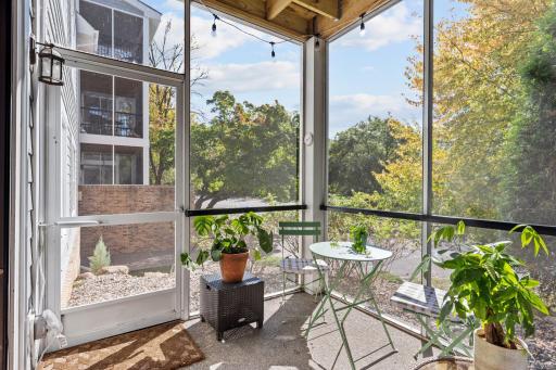 Screened porch with private entrance and views of surrounding greenery.