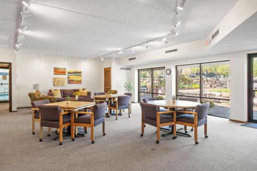 Another view of the community room highlighting flexible seating and gathering space.