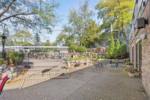 Community patio with landscaped surroundings and outdoor seating areas.