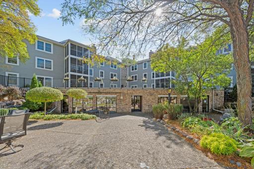 Rear exterior view of the building showcasing the shared courtyard and landscaped grounds.