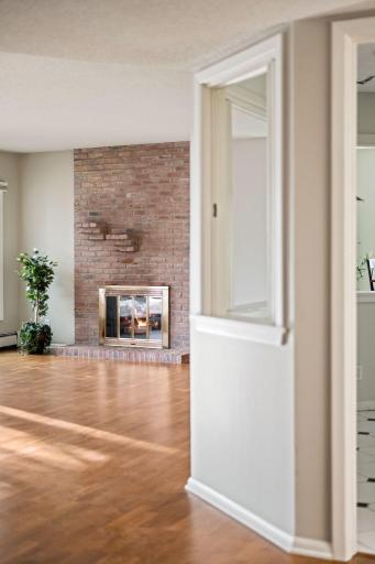 Charming interior view highlighting the cozy brick fireplace and open layout.