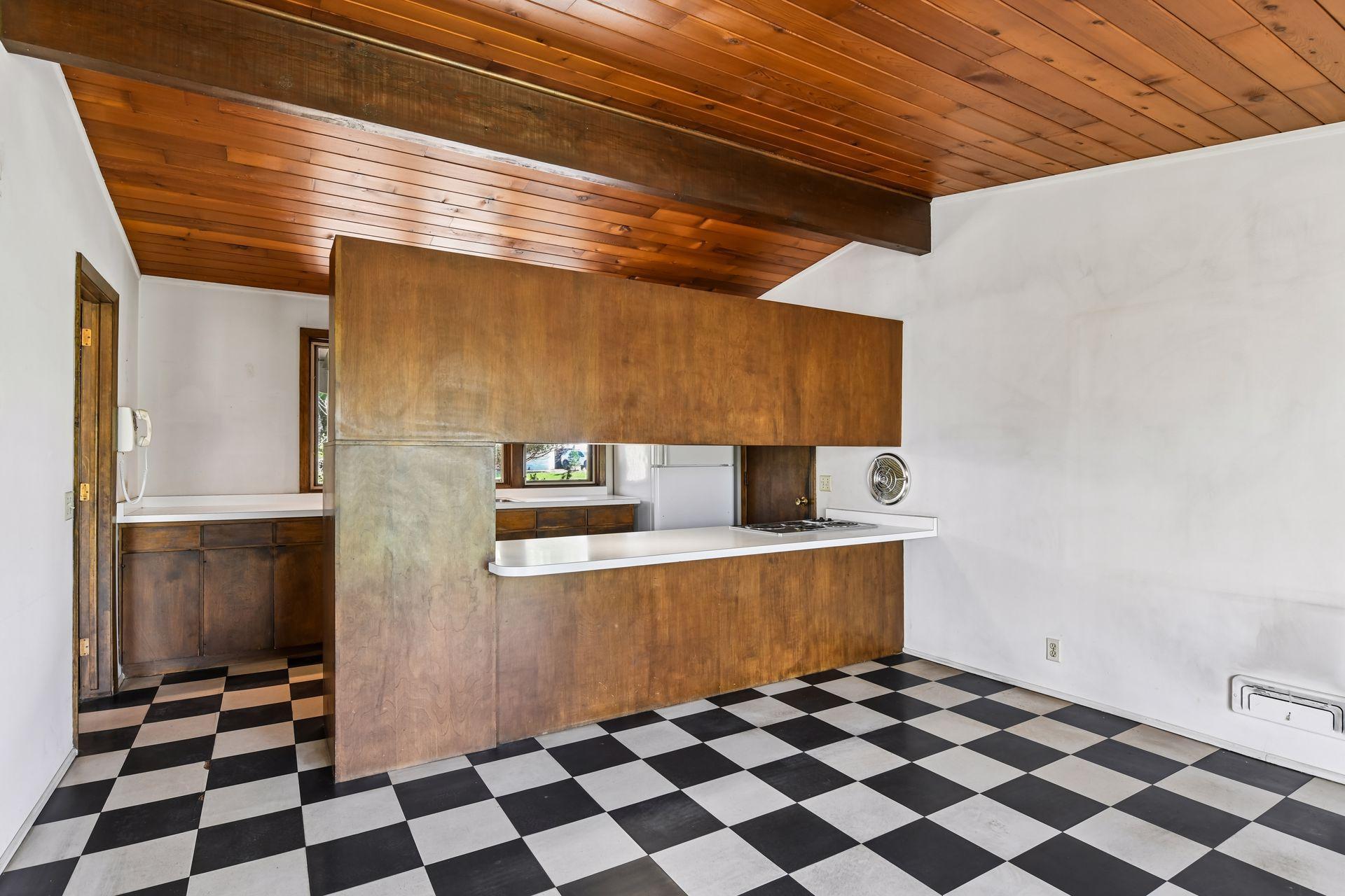 Galley-style kitchen opens to a large informal dining area, providing an ideal opportunity to remodel and create a grand gathering kitchen.