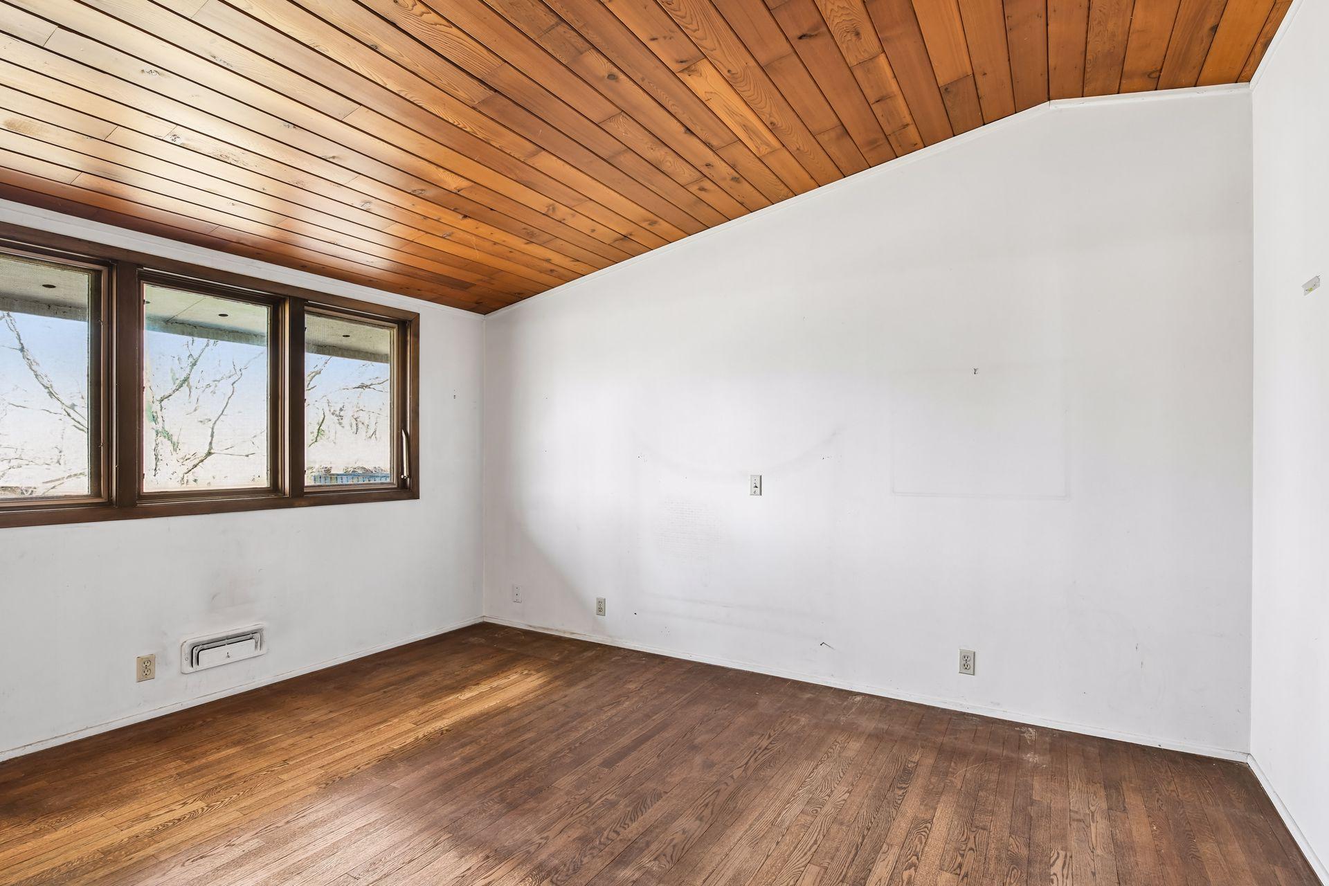 All three bedrooms have hardwood floors and vaulted ceilings.