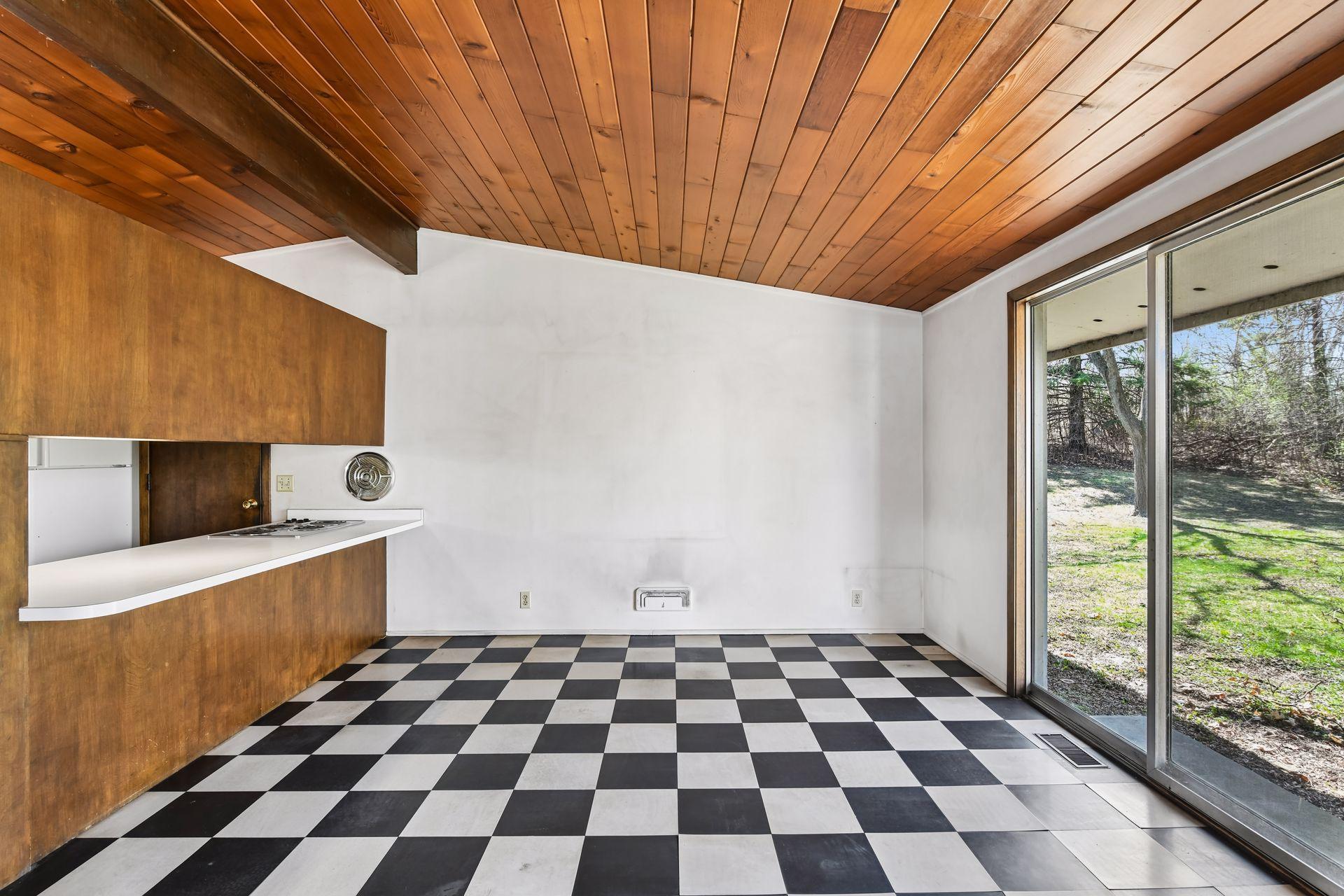Galley-style kitchen opens to a large informal dining area, providing an ideal opportunity to remodel and create a grand gathering kitchen.