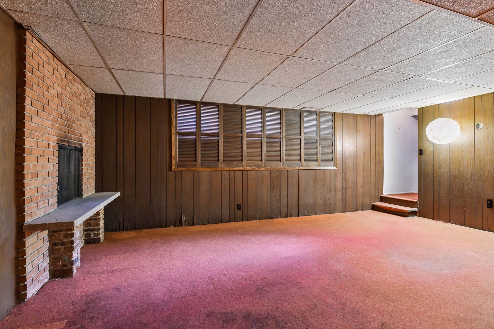 Downstairs is only about 3/4 finished as a dark panel family room.