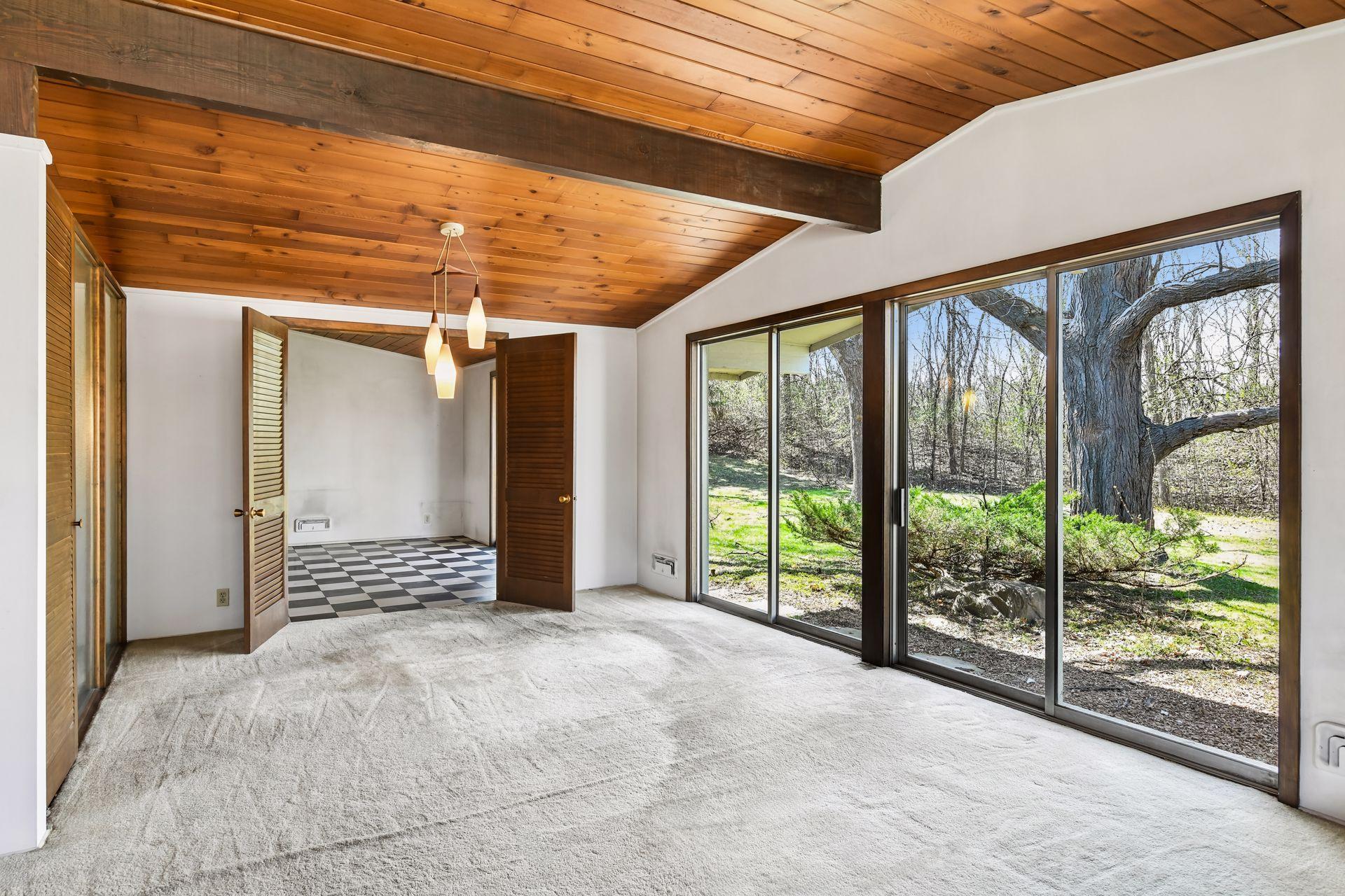 Expansive main floor living room/dining room has walls of patio doors opening to the big back yard.