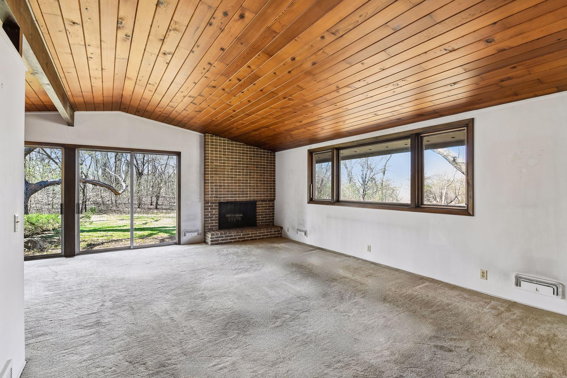 Living room boasts brick fireplace.