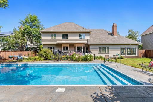 The generous inground pool features wide entry steps and plenty of surrounding space for relaxing poolside.