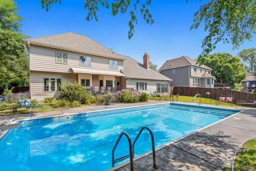 Mature trees and established landscaping create a picturesque backdrop for this exceptional outdoor living space.