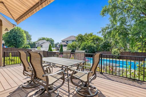 Imagine summer dinners here! The spacious maintenance-free deck offers wonderful views of the pool and backyard.