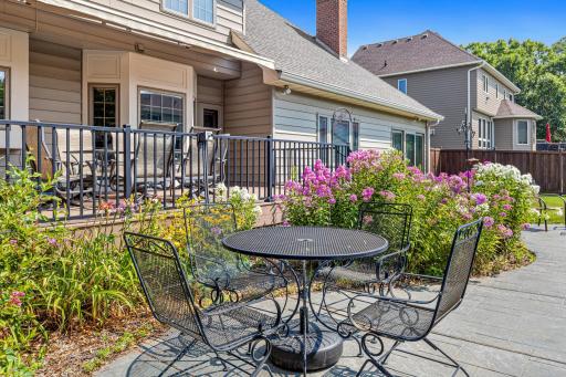 Colorful gardens surround the poolside patio, creating an inviting spot for conversation, dining and summer entertaining.