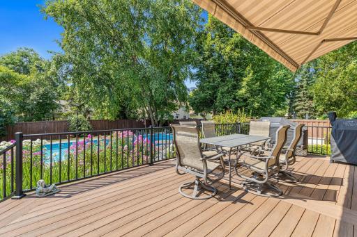 The maintenance-free deck overlooks the pool and gardens- an ideal setting for outdoor meals and warm summer evenings.