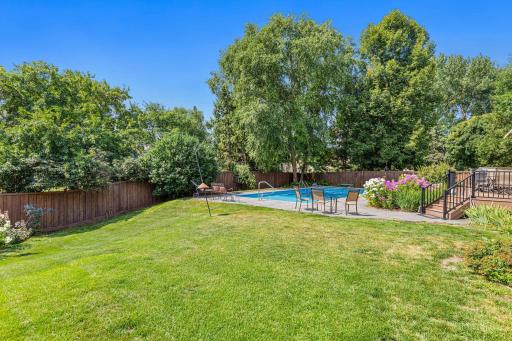 Vacation at home! The fully fenced backyard opens to your own outdoor retreat with an inground pool, beautiful gardens and plenty of green space.