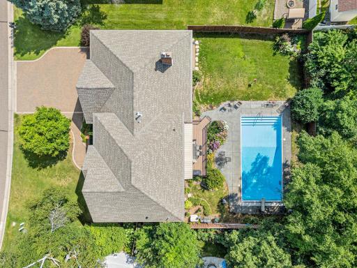 “Club Med” from above! The fully fenced backyard brings together the inground pool, patio, deck, gardens and lawn in one exceptional outdoor retreat.