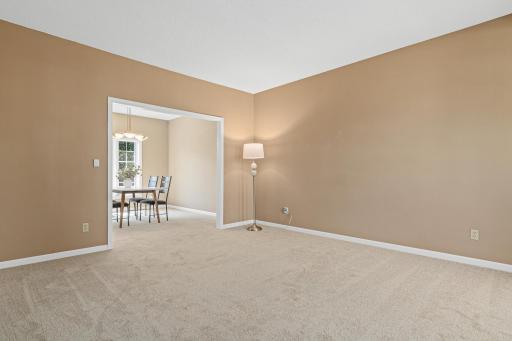 View from the living room to the dining room with new carpet throughout.